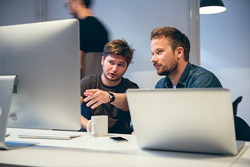 Two men reviewing data insights and reports